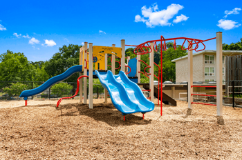 A playground with two slides at a park